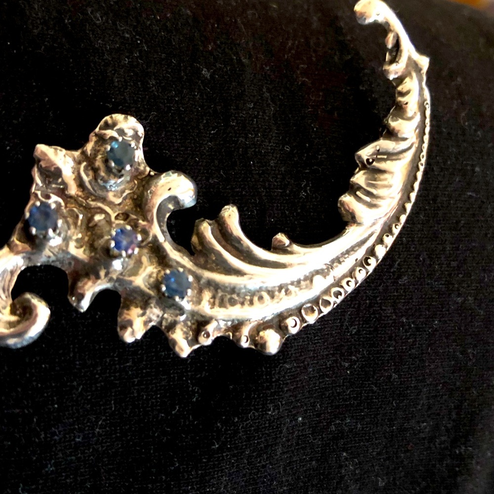 Vintage Art Nouveau Silver brooch with 4 deep blue stones.
